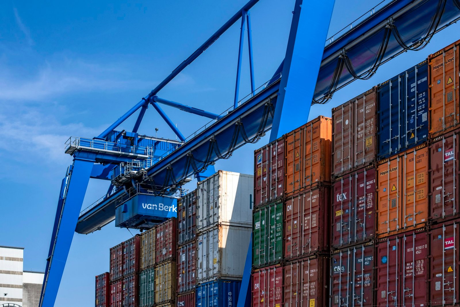 Blue and red shipping containers in a storage yard